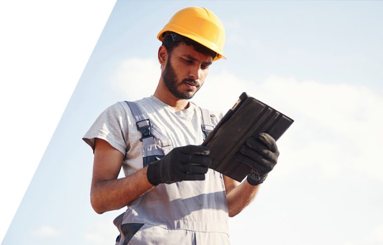 A roofer using roofing CRM software on a tablet